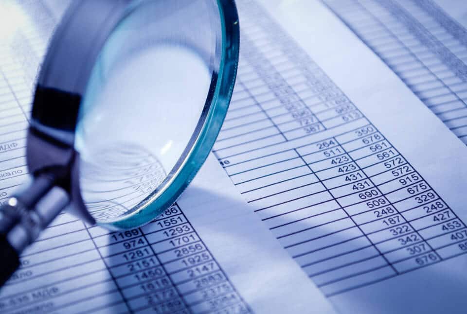 magnifying glass and spreadsheet