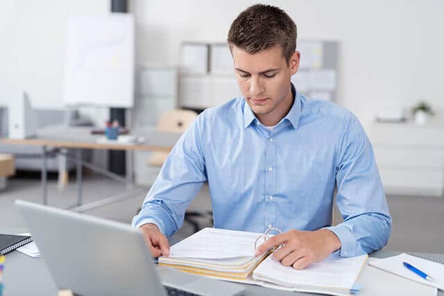 man reviewing an office manual