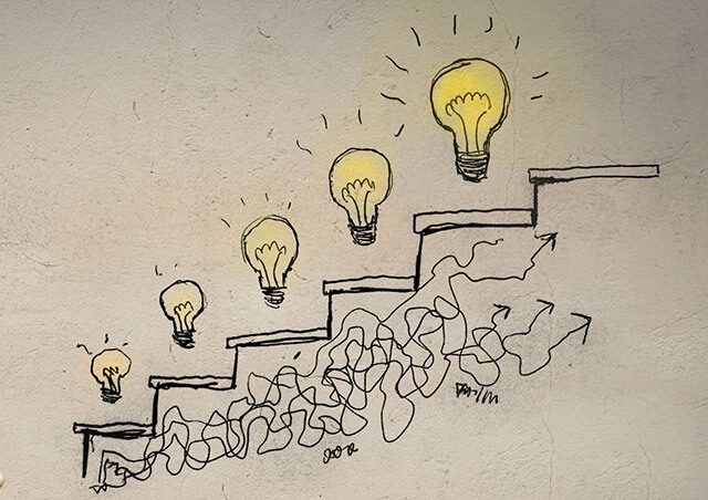 sketch of lightbulbs (representing ideas) climbing stairs